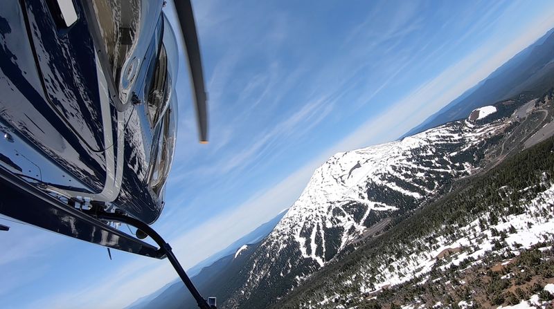 Helicopter over snowy mountain