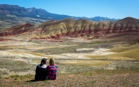 Two women looking at Painted Hills.