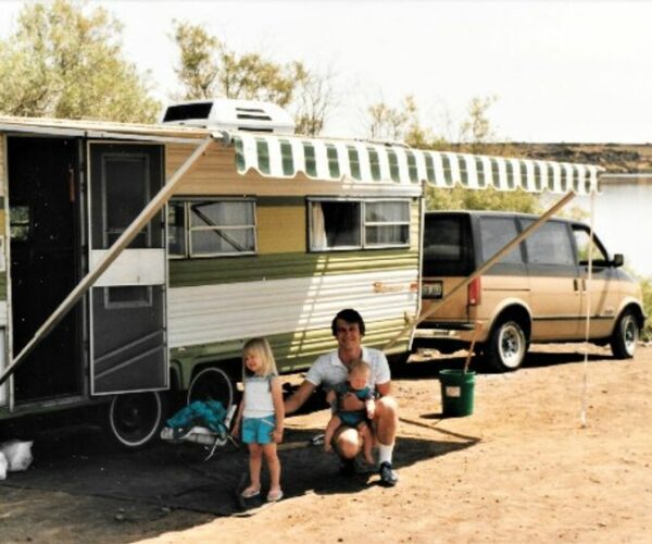 Man and child with rv at lake