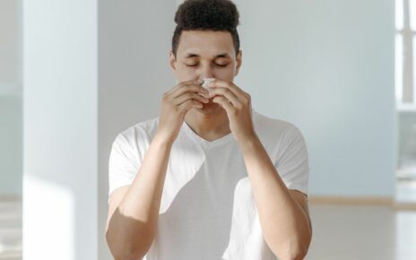 Man wiping nose